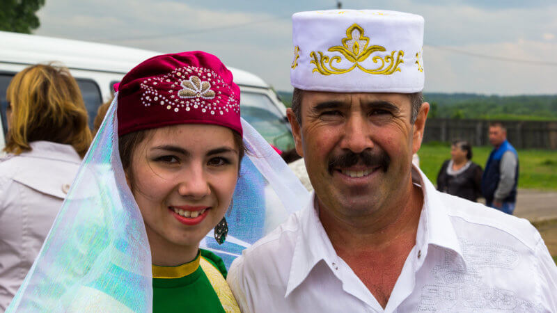 A Tatar man and woman wearing traditional hates.